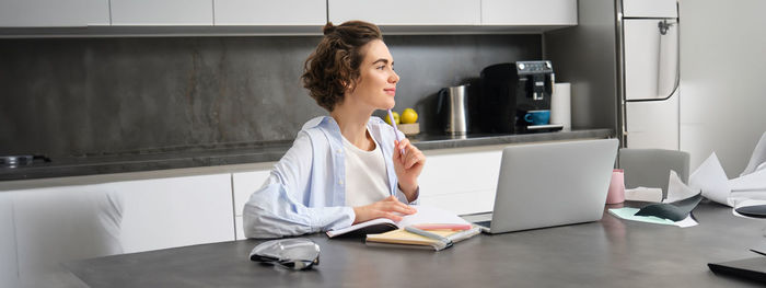 Side view of young businesswoman working at office