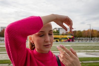 Close-up of young woman standing in city