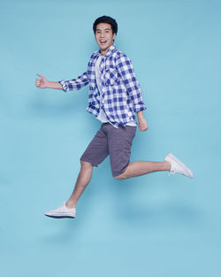 Portrait of smiling man against blue background