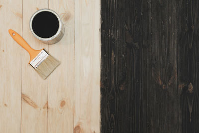 High angle view of coffee cup on wooden table