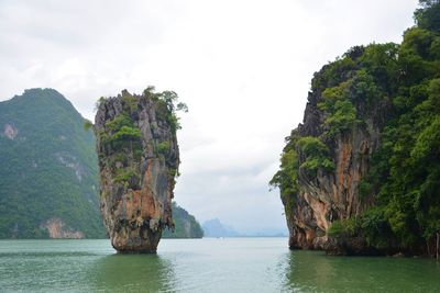 Scenic view of sea and mountains against sky