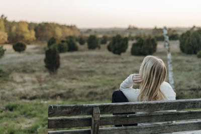 Portrait of woman sitting on land