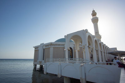 View of historical building over sea against sky