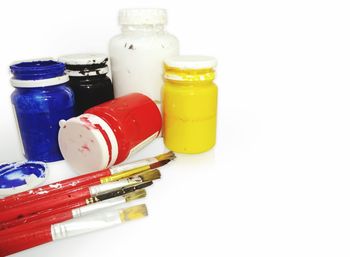 High angle view of bottles on table against white background