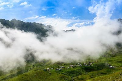 Scenic view of mountains against cloudy sky