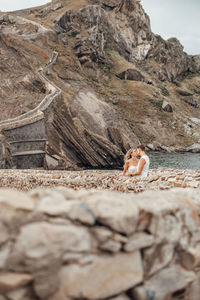 Surface level of man relaxing on rock