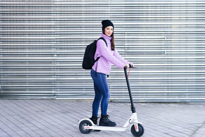 Full length portrait of woman with skateboard