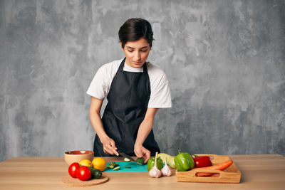 Young woman preparing food on table