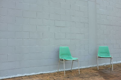 Empty chair against wall