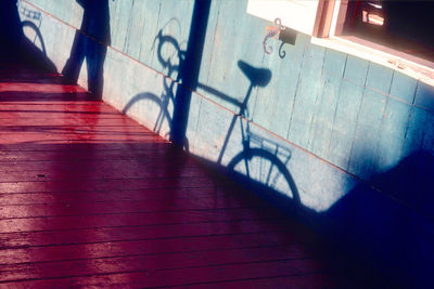 High angle view of bicycle shadow on staircase