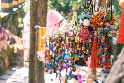 Colorful bead necklaces hanging at market for sale