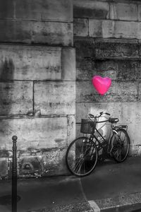 Close-up of bicycle against red wall