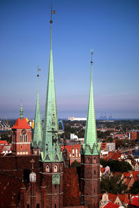 High section of illuminated city against blue sky