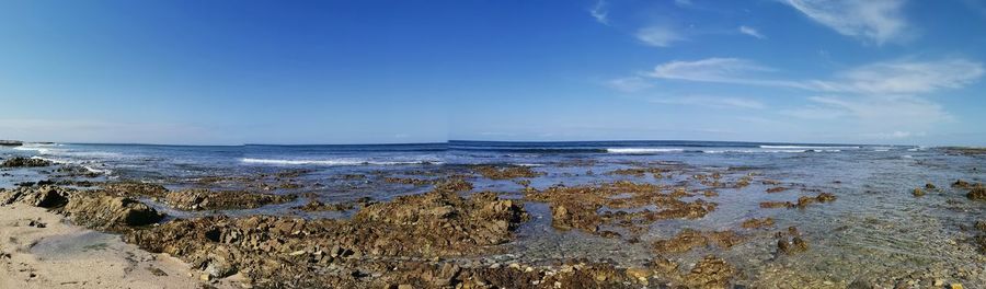 Scenic view of sea against blue sky