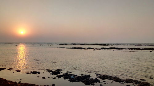 Scenic view of sea against clear sky during sunset