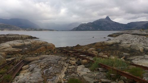 Scenic view of mountains against cloudy sky