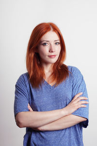 Portrait of young woman against white background