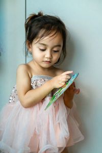 Close-up of girl looking at book