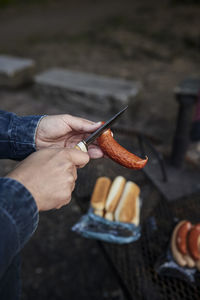 Cropped hand of man holding food