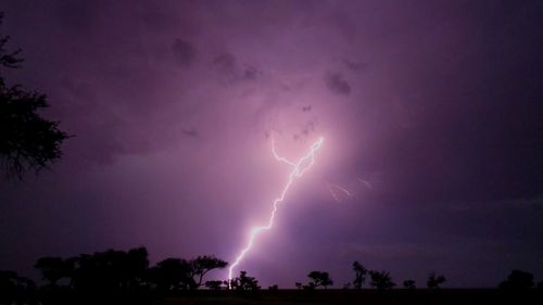 Low angle view of lightning against sky at night