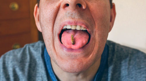 Close-up of man eating insect