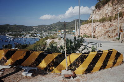 Scenic view of road by mountains against sky