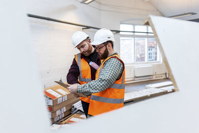 Engineers discussing over document at construction site