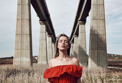 Portrait of smiling woman against sky