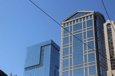 Downtown chicago, low angle view of modern buildings against clear blue sky