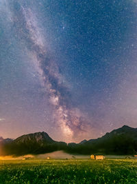 Scenic view of field against sky at night