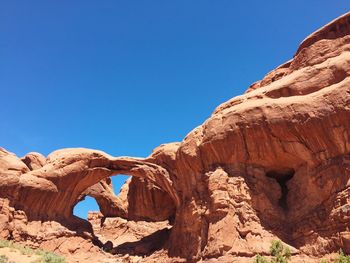 Double arch against clear blue sky at arches national park