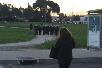 Rear view of women walking on street in city