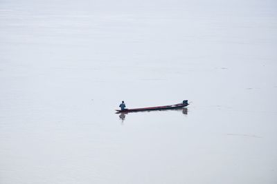 High angle view of man on small boat in sea