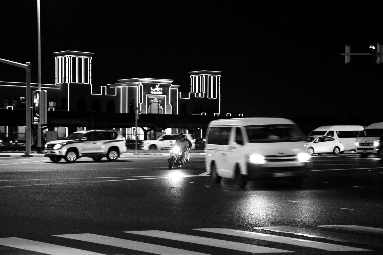 VEHICLES ON ROAD AT NIGHT