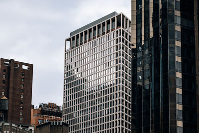 Low angle view of modern buildings against sky in city