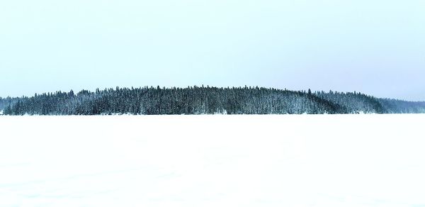 Scenic view of snow covered land against clear sky