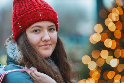 Portrait of girl holding shopping bag in store