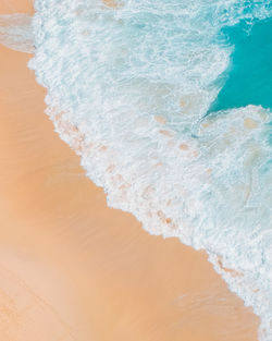 High angle view of waves rushing towards shore