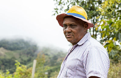 Portrait of man standing against plants