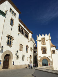 Low angle view of buildings against blue sky