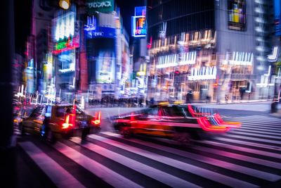 Cars on city street at night