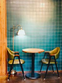 Empty chairs and table against wall at home