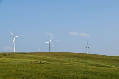 Windmill on field against sky