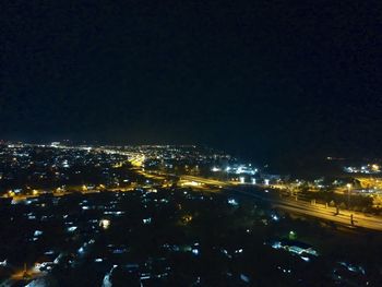 High angle view of illuminated buildings in city at night