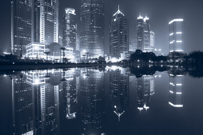 Reflection of illuminated buildings in city