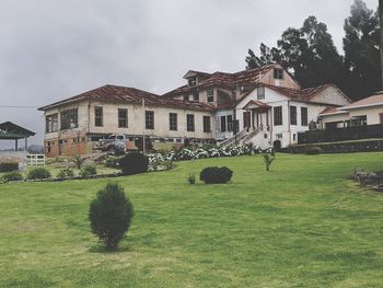 Lawn by building against sky