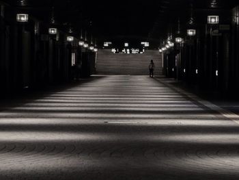 Illuminated underground walkway at night