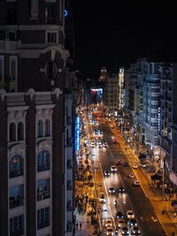 High angle view of city lit up at night