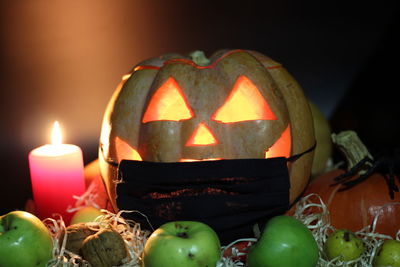 Close-up of illuminated pumpkin against black background