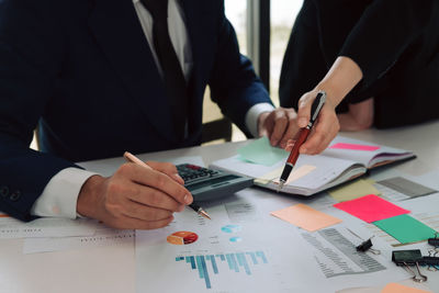 Midsection of man working on table